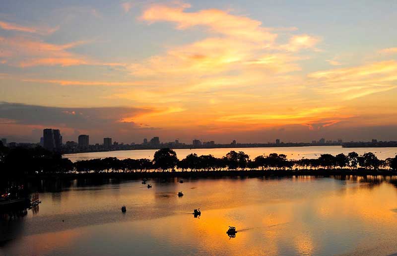 Many people enjoy cycling or walking along the scenic paths that surround West Lake.